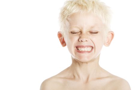 Portrait of a young blond Caucasian boy (4-7) on white background.の写真素材