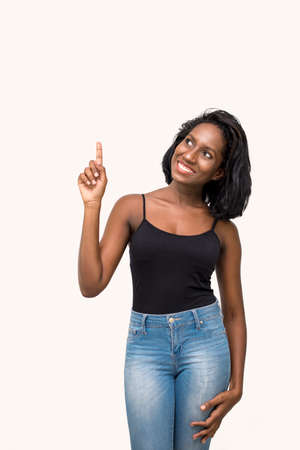 Woman pointing and looking upの写真素材