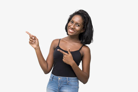 Woman pointing to left with fingersの写真素材