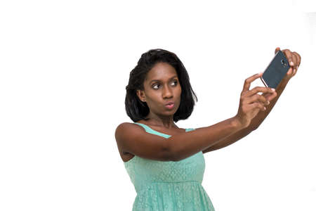 Woman making duck face and taking selfieの写真素材