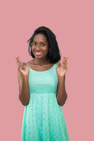 Woman with fingers crossedの写真素材