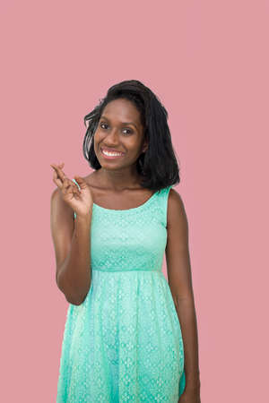 Pretty lady with fingers crossedの写真素材