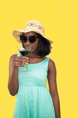 Woman sips cocktail drinkの写真素材