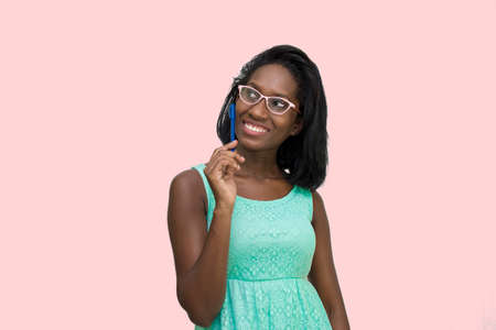 Woman wearing glasses holding penの写真素材