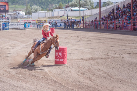 Williams Lake, British Columbia/Canada - July 2, 2016: horse and rider cut around the second barrel during the barrel racing competition at the 90th Williams Lake Stampedeのeditorial素材