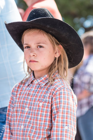 Williams Lake, British Columbia/Canada - July 2, 2017: a young girl in a cowboy hat watches the Stampede Parade, a popular annual event in downtown Williams Lake.のeditorial素材
