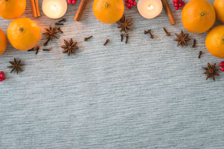 Christmas arrangement of holiday spices, oranges and candles