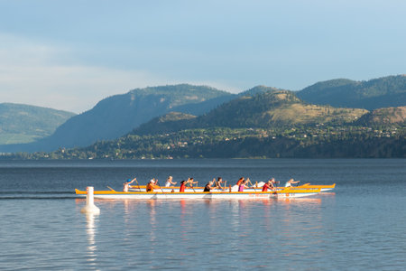 Penticton, British Columbia/Canada - June 13, 2019: close-up of teams rowing dragon boats across Skaha Lake. Penticton hosts a large dragon boat festival each year.のeditorial素材