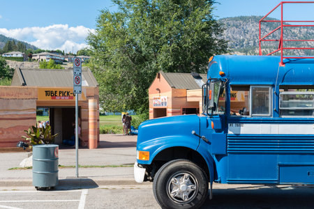 Penticton, British Columbia/Canada - September 2, 2019: shuttle bus parked in front of Coyote Cruises River Float company, dropping off customers who floated down the Penticton River Channel.のeditorial素材