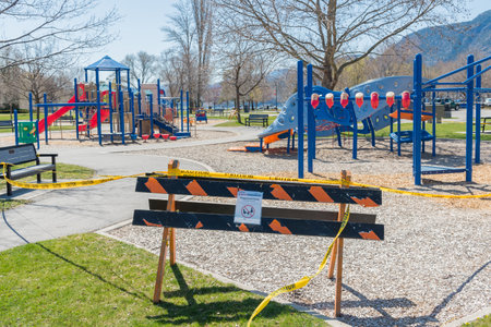 Penticton, British Columbia/Canada - April 16, 2020: cordon tape and signs block  the children's...