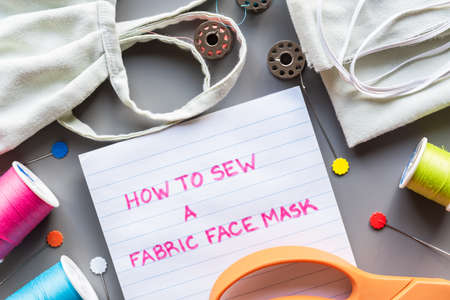 How to sew a fabric face mask, flat lay arrangment of face mask and sewing equipment for making maskの写真素材