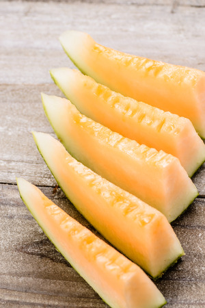 melon pieces on the wooden boardの写真素材