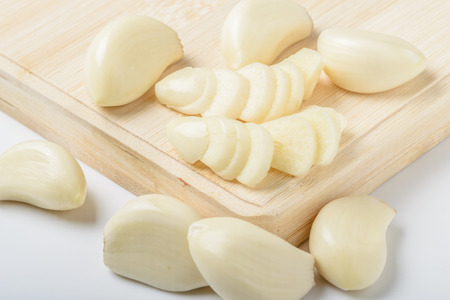 garlic clove on the wooden boardの写真素材