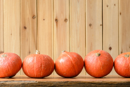 orange pumpkins on the wooden boardの写真素材