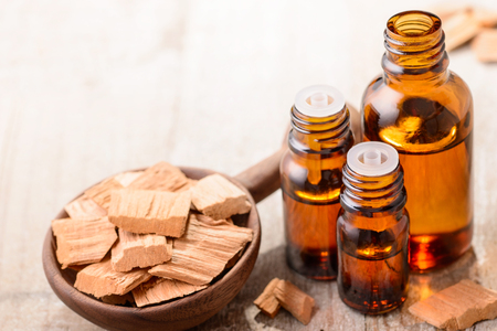 Sandalwood essential oil on the wooden boardの写真素材