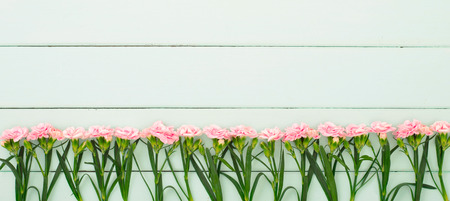 fresh carnation flowers in the wooden boardの写真素材
