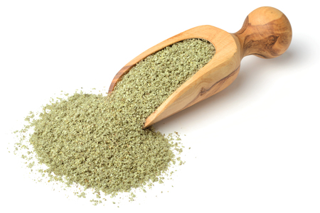 rubbed sage in the wooden scoop, isolated on whiteの写真素材