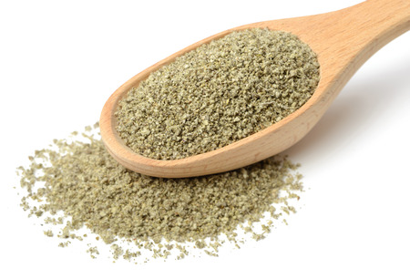 dried sage powder in the wooden spoon, isolated on whiteの写真素材