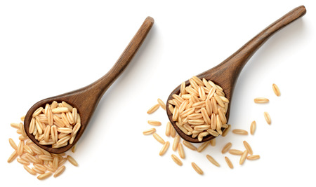 uncooked oats in the wooden spoon, isolated on white backgroundの写真素材