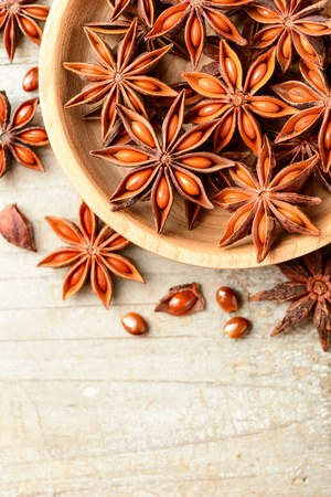 star anise fruits on the wooden board, top viewの写真素材