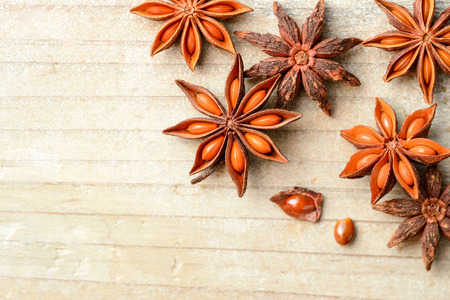 star anise fruits on the wooden board, top viewの写真素材