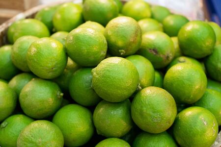 pile of Fresh green lemon lime for sale in the marketの写真素材