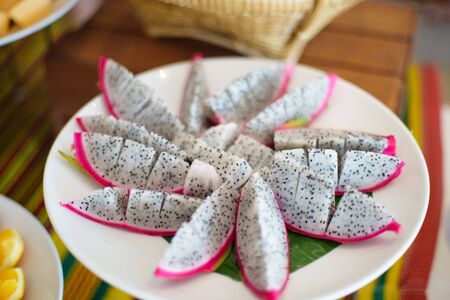 Beautifully Fresh Sliced Pitaya dragon fruit on white plateの写真素材
