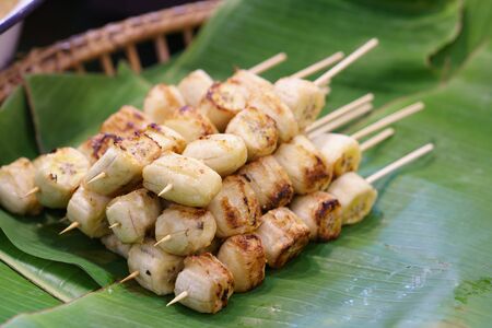 Grilled Banana With Coconut Sauce on A banana leaf. Thai Dessertの写真素材