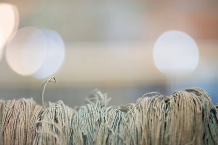 Close up thread linen fabric on Bokeh Light background with copy spaceの写真素材