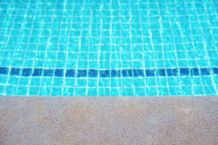 Rippled surface of Swimming pool blue water sun reflecting sleek background