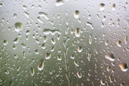 rain drops on glass widow of a car after the rainの写真素材