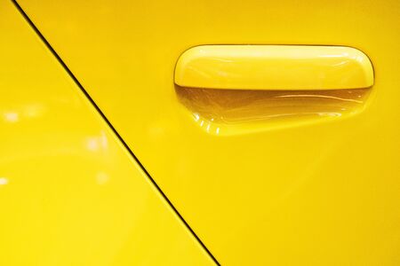 yellow Car door handle Using wallpaper or backgroundの写真素材