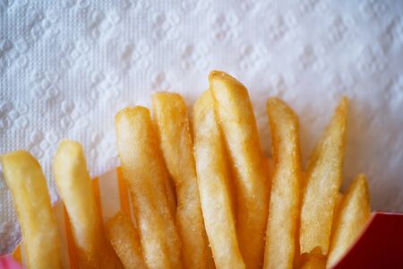 Tasty Golden French fries in paper cup