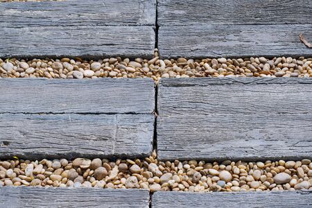 Walkway made old wood and stone in the garden