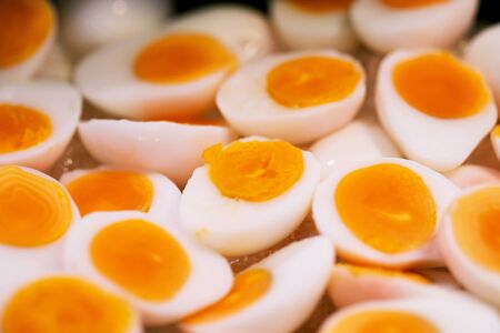 Hard boiled chicken egg cut in half at thai street food marketの写真素材