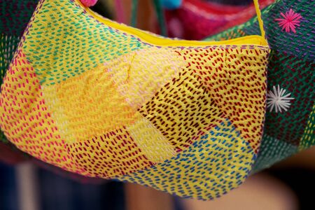 Close up of Handicrafts embroidered bag with traditional pattern texture background