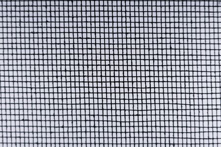 Blurred  Abstract Minimal style black and whith rays of sunlight cast shadows on the wire mesh steel metalの写真素材