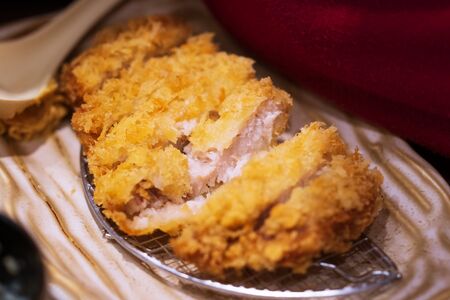 Close up of Tonkatsu panko breaded deep fried pork cutlet thai street food marketの写真素材