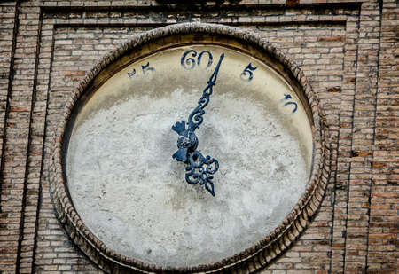 Close-up of a turret clock with painted-over clock face in Parma, Italy