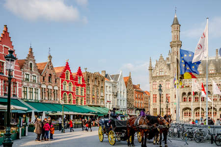 Bruges, Belgium - March 2013 - Horse carriages wait for customers on Grote square in March 2013 in Bruges  The Belgian city of Bruges is a famous tourist destination and   UNESCO world heritage listed for its medieval center のeditorial素材