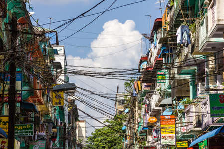 Yangon, Myanmar - November 3, 2013 - Power cables zig-zag between housing blocks in the Indian quarter on November 3, 2013 in Yangon  The Indian quarter of Yangon is an especially poor, muslim dominated area west of Sule Pagoda in the town center のeditorial素材
