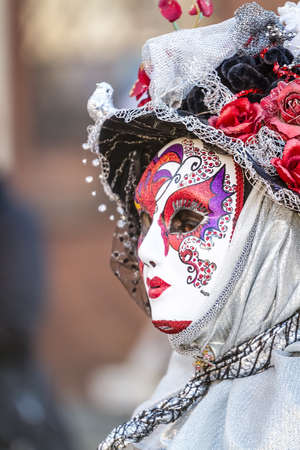 Schwaebisch-Hall, Germany - February 23, 2014 - Woman, dressed up in a Venetian style costume with a colorful mask attends the Hallia Venetia Carnival festival on February 23, 2014 in Schwäbisch-Hall のeditorial素材