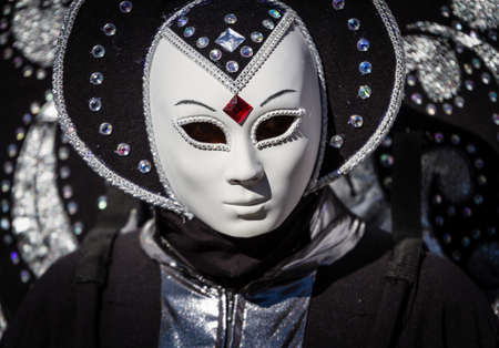 Schwaebisch-Hall, Germany - February 23, 2014 - Woman, dressed up in a Venetian style costume with an alien-like face mask attends the Hallia Venetia Carnival festival on February 23, 2014 in Schwäbisch-Hall のeditorial素材