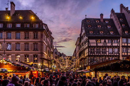 Strasbourg, France - December 8, 2013 - Crowds walk up Rue Merciere to the Christmas Market at dusk on December 8, 2013 in Strasbourg.のeditorial素材