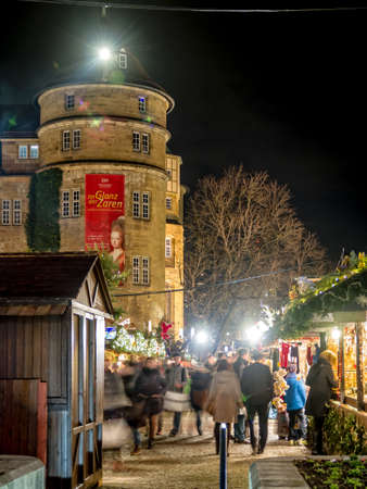 Stuttgart, Germany - December 21, 2013 - People stroll over the Christmas Market next to the Old Palace (Altes Schloss) at night on December 21, 2013 in Stuttgart.のeditorial素材
