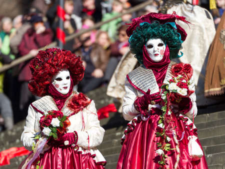 Schwaebisch-Hall, Germany - February 23, 2014 - Two women, dressed up in Venetian style flower costumes attend the Hallia Venetia Carnival festival on February 23, 2014 in Schw?bisch-Hall.のeditorial素材