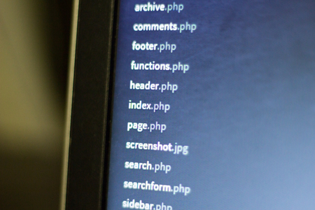 Web development project file system. PHP scripts dashboard on laptop screen.