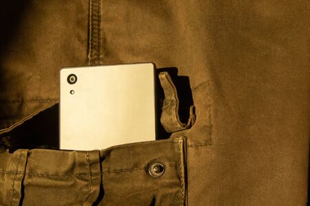 Modern smartphone in jeans pocket. Digital gadgets concept.