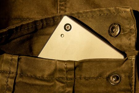 Modern smartphone in jeans pocket. Digital gadgets concept.