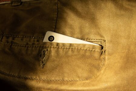 Modern smartphone in jeans pocket. Digital gadgets concept.の写真素材